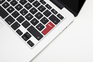 Laptop's keyboard with red Abort key and copyspace
