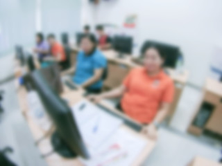 Defocused student study computer classroom for background.