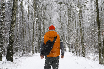 Man Winter in the forest with backpack - 127185815