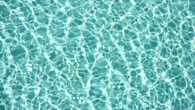 Shiny blue water in a swimming pool. (HD footage with sound)