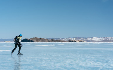 Tourists travel to Norway hiking ice skating on the frozen lake. Special long skate for long distances. Mounting under the ski boots. Location of Lake Baikal action. The Russian called Bayes or Loft.