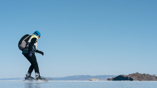 Tourists travel to Norway hiking ice skating on the frozen lake. Special long skate for long distances. Mounting under the ski boots. Location of Lake Baikal action. The Russian called Bayes or Loft.