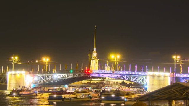 Opening the Palace Bridge on Neva river. Peter and Paul fortress on the background. Iconic view of St. Petersburg. Russia North Capital classic symbol. Tourist boats and barges under the bridge