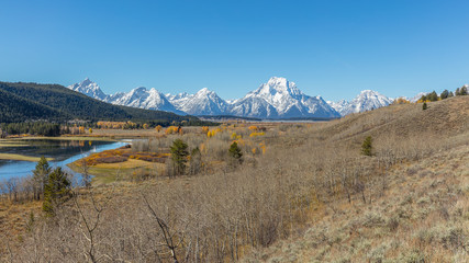 Beautiful snow-capped mountains. Golden autumn. Grand Teton National Park, Wyoming, USA