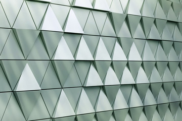 Abstract close-up view of modern aluminum ventilated triangles on facade 