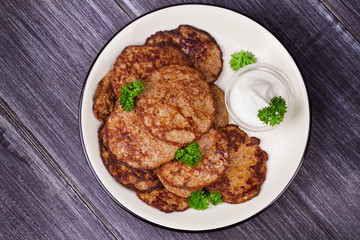 Liver Patties with Sour Cream and Parsley. Liver Cakes or Fritters of Liver. Healthy snack or take-away lunch bites. View from above, top studio shot