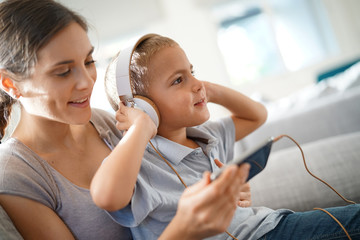 Mother and son listening to music with smartphone