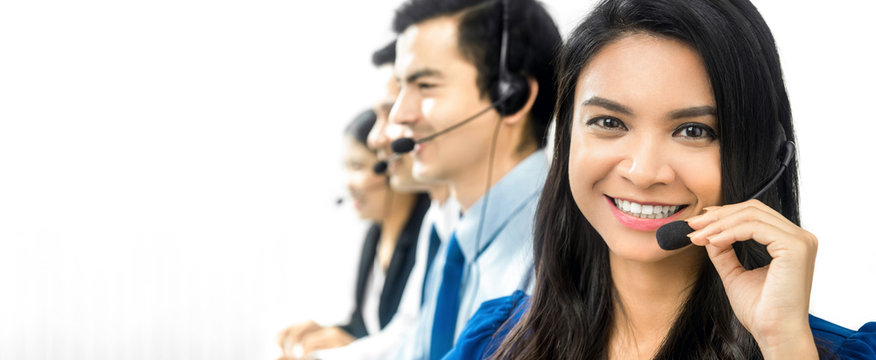 Smiling Asian call center (or telemarketer) team
