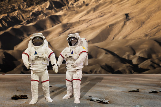 astronaut wearing pressure suit in a sand dune background
