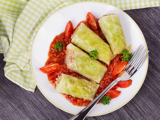 Cabbage rolls with meat, rice and vegetables in tomato sauce. Stuffed cabbage leaves with meat. Dolma, sarma, sarmale, golubtsy or golabki - traditional dish in many countries