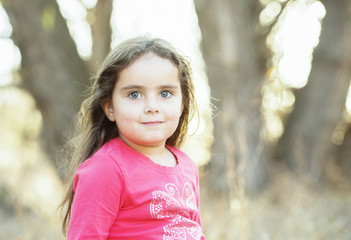 Little Girl with Long Hair Playing Outside in a Natural Environment