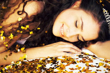 beauty young girl in gold confetti and tiara, little princess ce