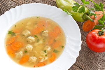 Soup with meatballs and vegetables in plate
