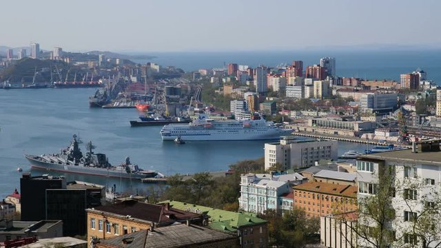 Port of Vladivostok. Timelapse top View of the Naval station with the exhaust from the dock a passenger ship. Business life the seaside town.