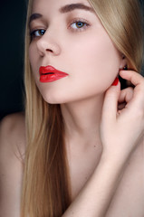 Fototapeta premium Close portrait of a beautiful young fashion girl with red lips. Make up, beauty, red lips