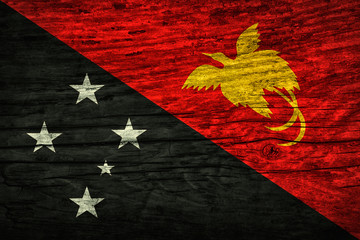 The national vintage flag of Papua New Guinea on wooden surface