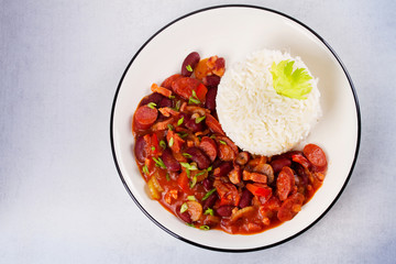 Red Beans with Sausages, Pancetta, Celery Stalks and Rice. View from above, top studio shot