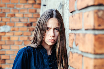 Pretty girl on brick wall