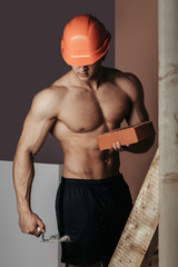 Fototapeta na wymiar sexy muscular man builder on ladder