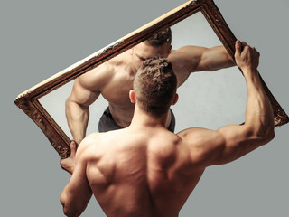 sexy muscular man with mirror