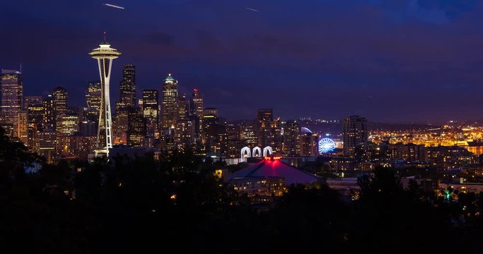 Seattle, Washington, USA - illuminated skyline of Seattle with Space needle, harbor and Elliott Bay - view from Kerry Park at sunset with clouds - Timelapse with motion and zoom out 
