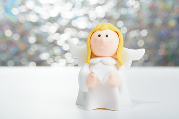 Toy angel with book in hand