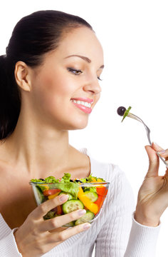 Portrait of happy smiling woman with vegetarian vegetable salad,