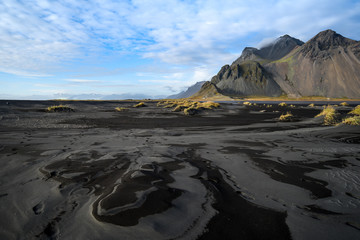 Mountains and volcanic lava sand in Stokksness, Iceland