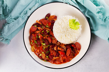 Red Beans with Sausages, Pancetta, Celery Stalks and Rice. View from above, top studio shot