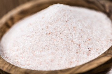Himalayan Salt on wooden background (selective focus)