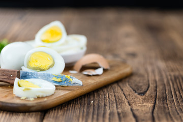 Old wooden table with sliced Eggs