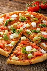 Fresh homemade pizza with chicken and garlic sauce on wooden bac