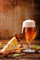 Poster Blue cheese appetizer and beer on brown vintage background © wideonet