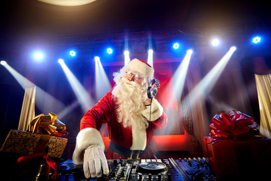 DJ Santa Claus mixing up some Christmas event.  Disco light arou