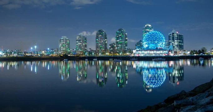 Vancouver, British Columbia, Canada - view over False Creek of illuminated Science World in Creekside Park at night - Timelapse with zoom out