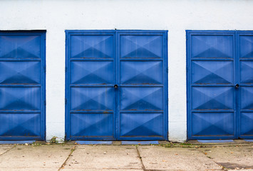 Doors of garage. Door has blue color. Angular doors as geometrical element in minimalist composition