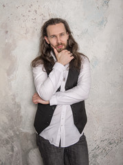 Portrait of handsome man with beard and long hair