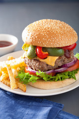 homemade cheese burger with peppers tomato onion