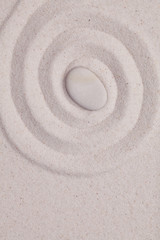 Fototapeta na wymiar Spiral in the white sand with white pebble