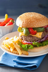 homemade cheese burger with peppers tomato onion