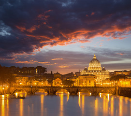 Fototapeta na wymiar Rome - Angels bridge and St. Peters basilica in red evening dusk