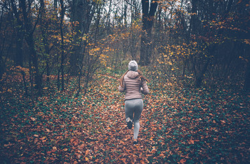 Young woman jogging on a cold day in the park