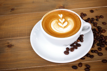 Coffee cup with on wooden table. View from the top