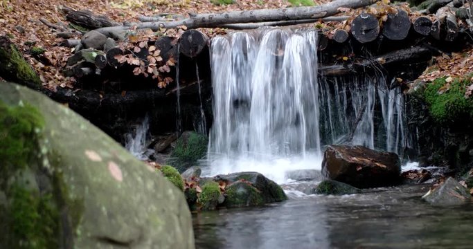 a Small Waterfall in the Mountains Autumn Forest With Yellow Foliage and Mossy Rocks