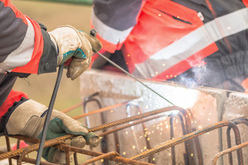 Worker welding armature on the bridge.Close-up shoot