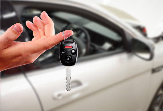 Fototapeta Dealer hand with a car key.