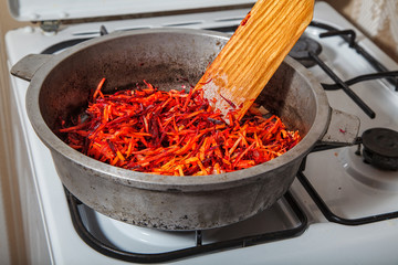 Fototapeta premium frying in a pan carrots and beets
