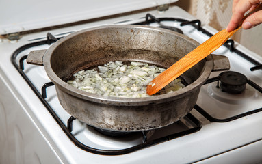 woman frying onions