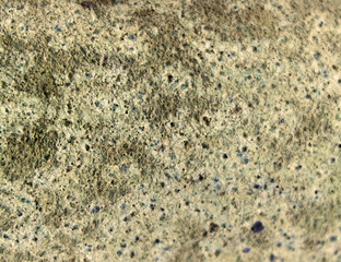 Rough stone background brown old wall with cracks and uneven layers