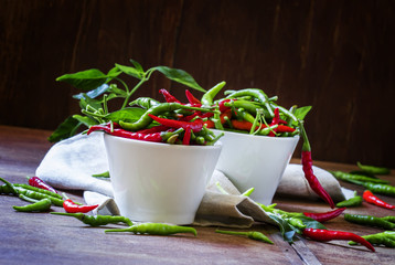 Hot peppers, old wooden background, selective focus